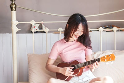 Young woman playing guitar