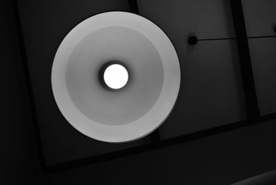 Directly below shot of illuminated pendant light in darkroom