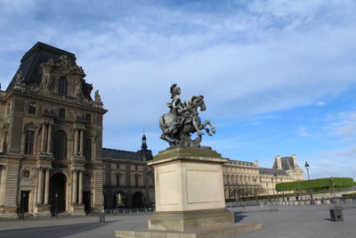 Low angle view of historical building against cloudy sky