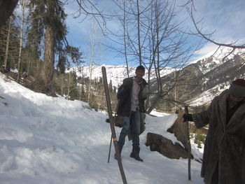 Man standing on snow covered landscape