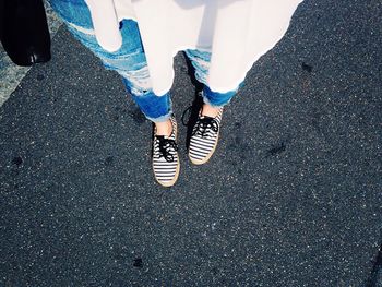 Low section of woman standing on tiled floor