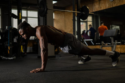 Side view of woman exercising in gym