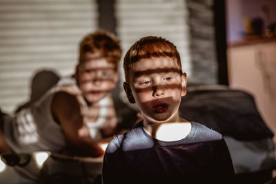 Sunlight falling on siblings at home