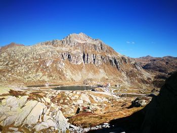 Scenic view of mountains against clear blue sky