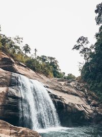 Scenic view of waterfall against clear sky