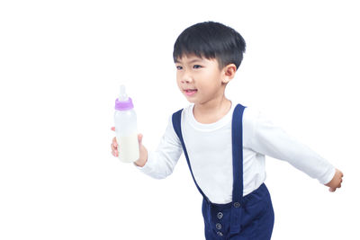 Boy standing against white background