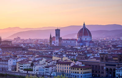 Aerial view of townscape against sky at sunset