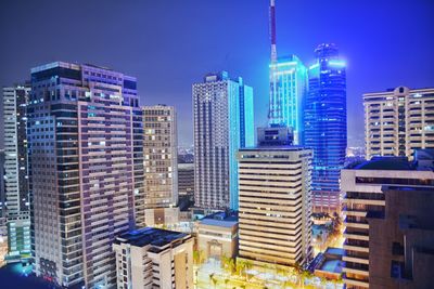 Low angle view of modern buildings against blue sky