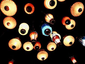 Low angle view of illuminated lanterns hanging from ceiling