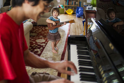 Midsection of man playing piano