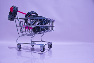 Close-up of metallic structure against pink background