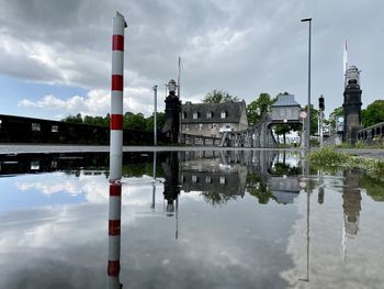 Reflection of building in puddle on lake