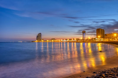 The beach of barcelona in spain at sunset