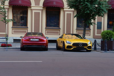 Car on street against buildings in city