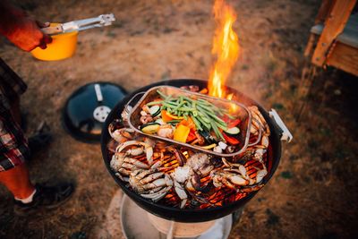 High angle view of crabs and vegetables on barbecue grill