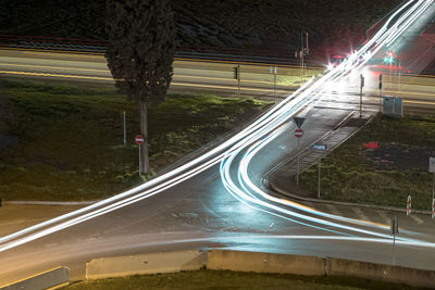 High angle view of light trails on road at night