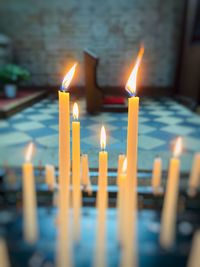 Close-up of lit candles in temple