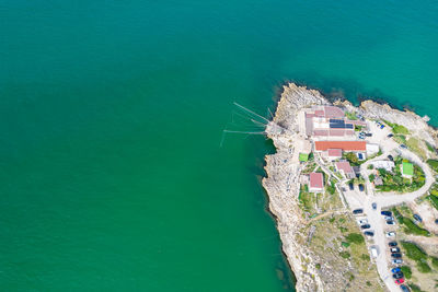 High angle view of buildings by sea