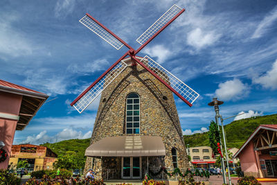 Low angle view of traditional windmill against sky