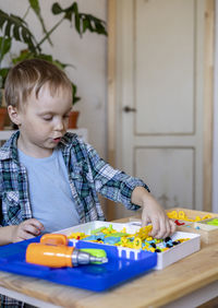 Boy playing with toys at home