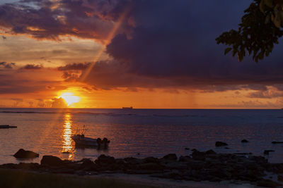 Fishing boat during sunset at albion beach, mauritius.