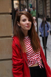 Portrait of beautiful young woman standing outdoors