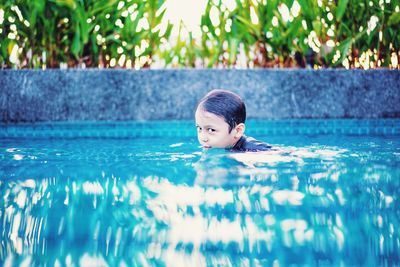 Boy swimming in pool