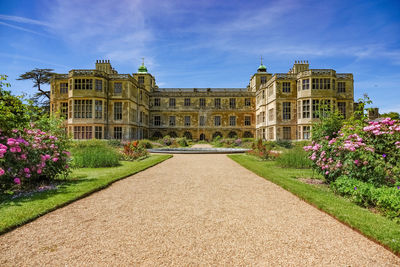 View of formal garden with building in background