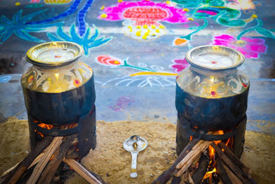 High angle view of illuminated candles on barbecue grill