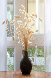 Close-up of flower vase on table at home