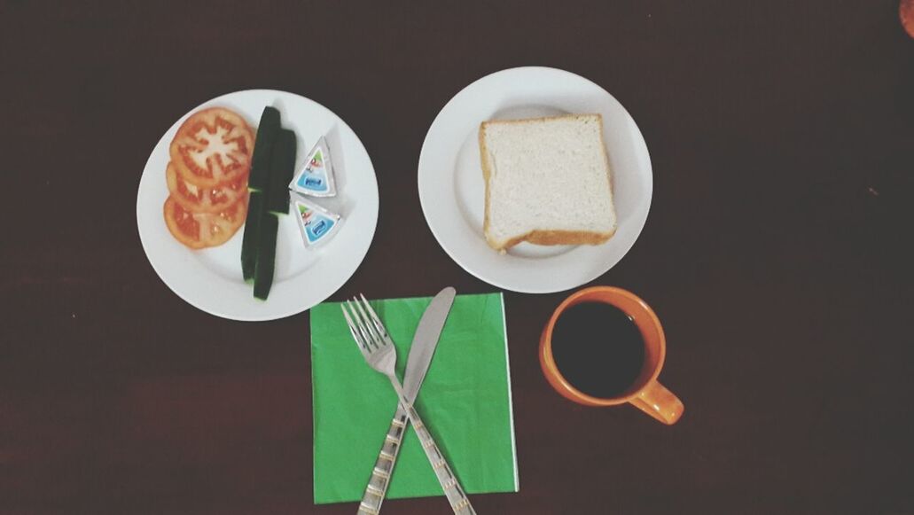 food and drink, coffee cup, drink, table, indoors, coffee - drink, refreshment, freshness, cup, saucer, still life, coffee, spoon, tea cup, plate, high angle view, tea, directly above, breakfast, food