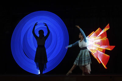 Digital composite image of dancers performing on stage