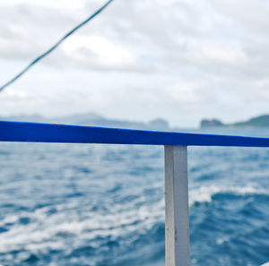 Close-up of railing against sea