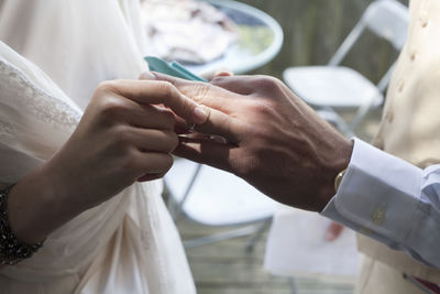 Midsection of couple holding hands