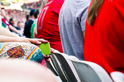 Rear view of people standing against red wall