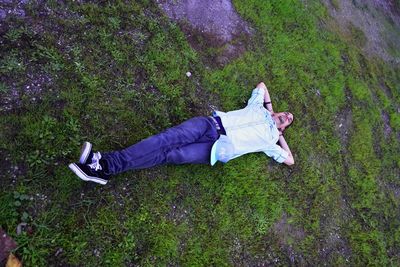 High angle view of person lying on grass