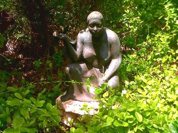 Statue against trees