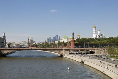 View of river by buildings against sky