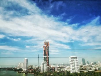 Tower in city against sky