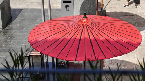 Close-up of red umbrella against built structure