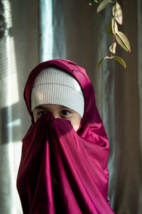 Portrait of a happy muslim toddler girl with hijab. natural light, selective focus.