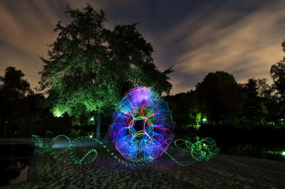 Light painting by tree at night