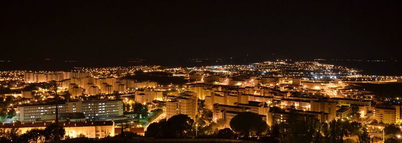Aerial view of city lit up at night