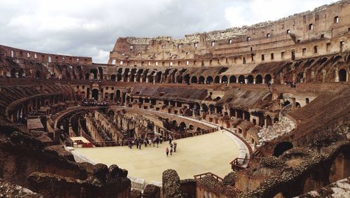 View of coliseum against cloudy sky