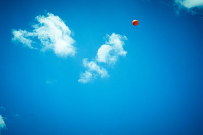 Low angle view of balloons against blue sky