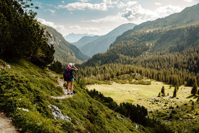 Rear view of man walking on mountain