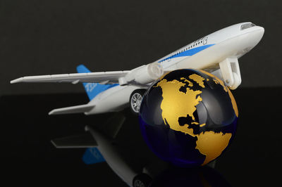 Close-up of toy airplane over black background