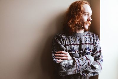 Portrait of man leaning against wall