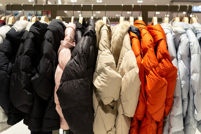 Winter coats hanging for sale on rack in store