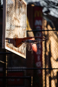Close-up of basketball hoop against fence